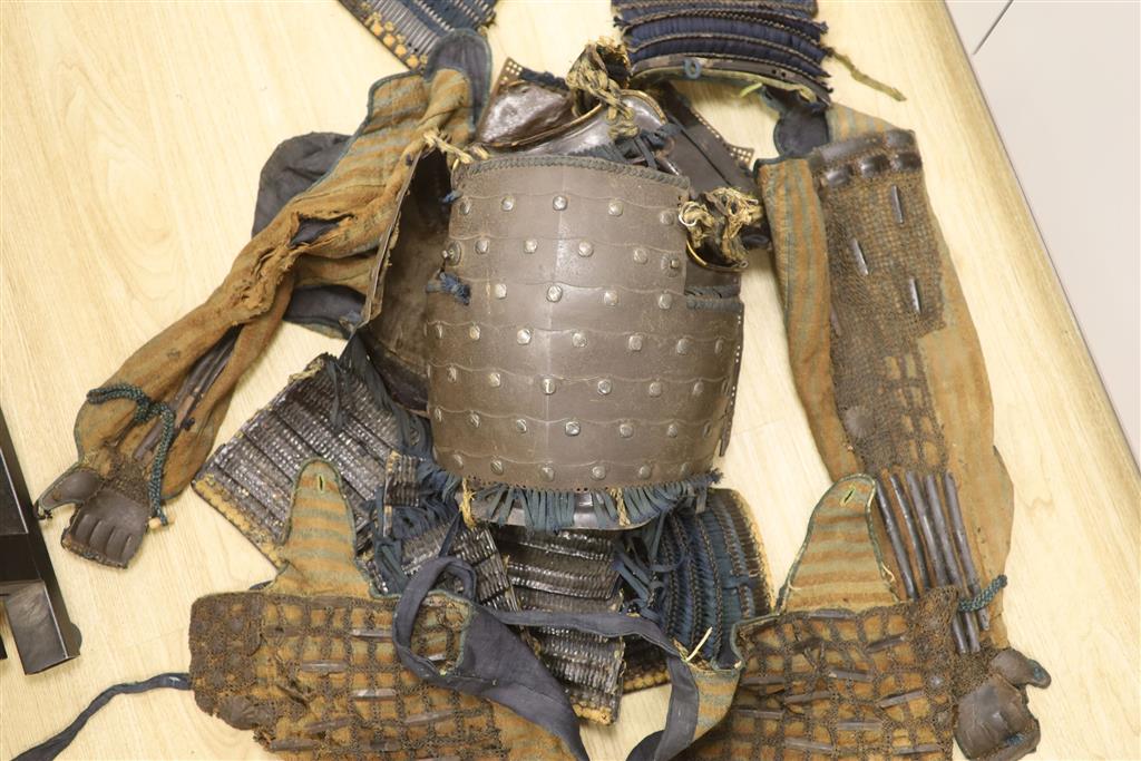 A Japanese iron armour Okegawa-do (Yoko-Hagi-horizontal make) 17th or 18th century, iron laminated breast and back plates with